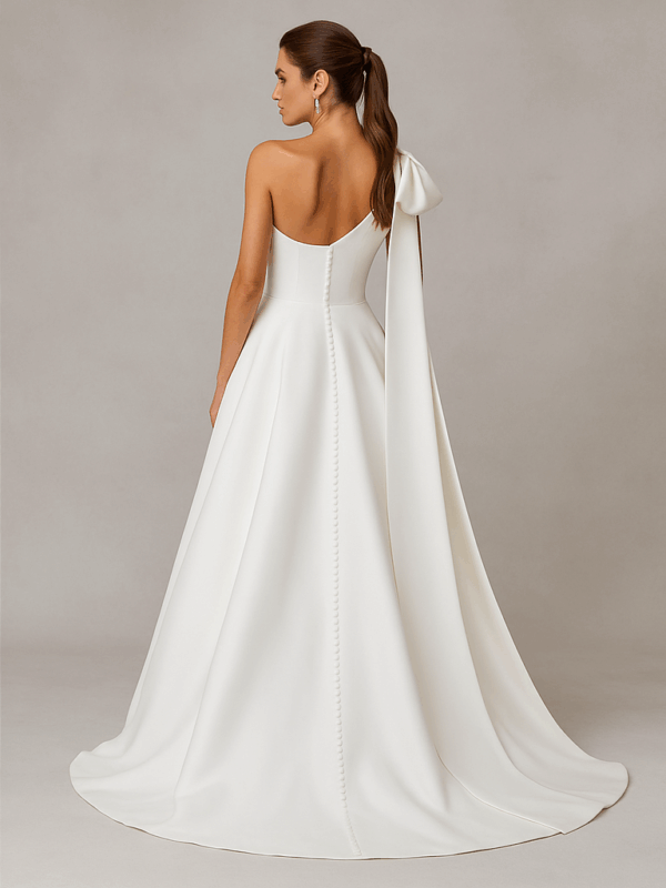 Adelaid satin wedding dress with statement bow and chapel train displayed on mannequin, side view, Laurel&Lace bridals boutique