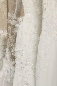 Luxury bridal boutique interior featuring four elegant lace wedding gowns on display and a warm, modern shopping atmosphere at Laurel & Lace in Atlanta